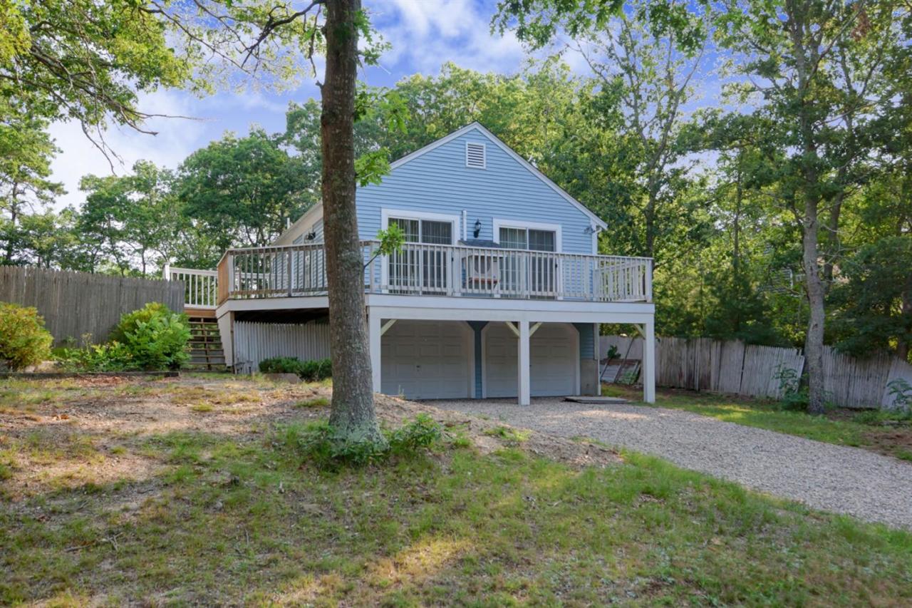 12 Santuit Pond Road Mashpee, MA 02649 - Photo 3 of 31 front view of a house with a yard