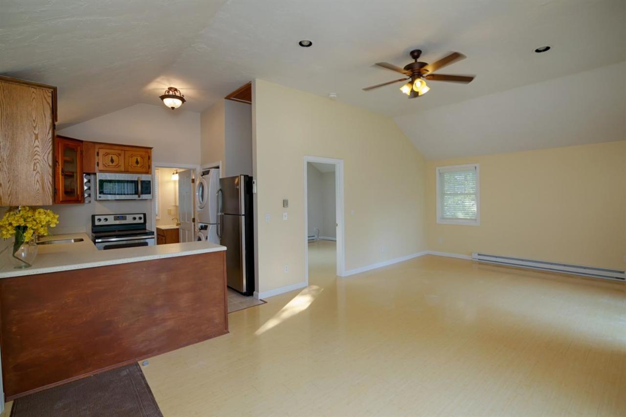 12 Santuit Pond Road Mashpee, MA 02649 - Photo 4 of 31 a large kitchen with stainless steel appliances a refrigerator sink and stove