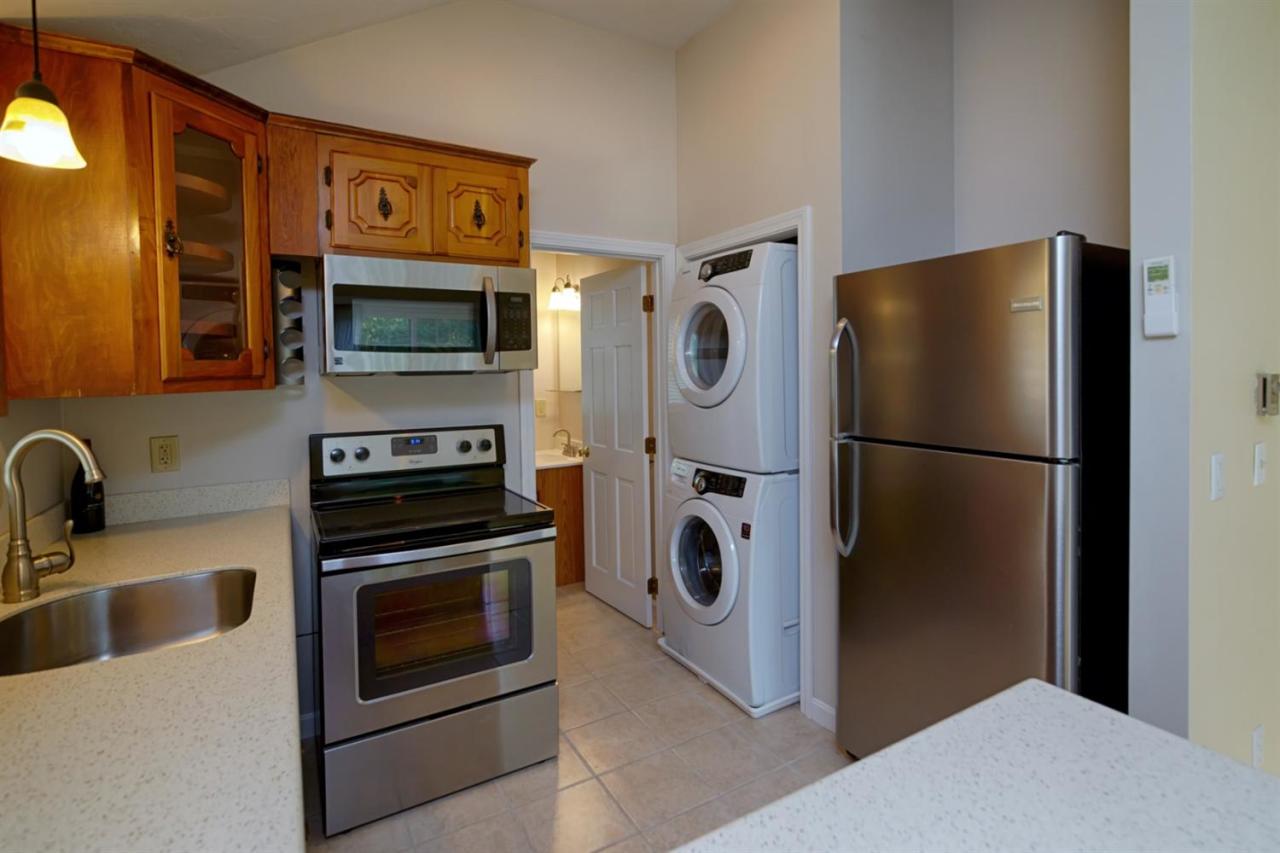 12 Santuit Pond Road Mashpee, MA 02649 - Photo 6 of 31 a kitchen with a refrigerator stove and microwave
