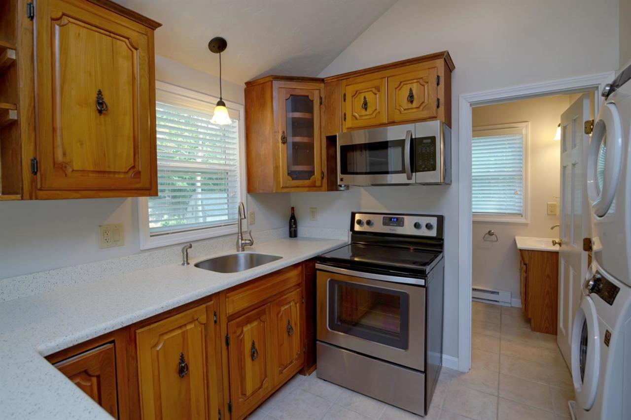 12 Santuit Pond Road Mashpee, MA 02649 - Photo 8 of 31 a kitchen that has a sink and a stove in it