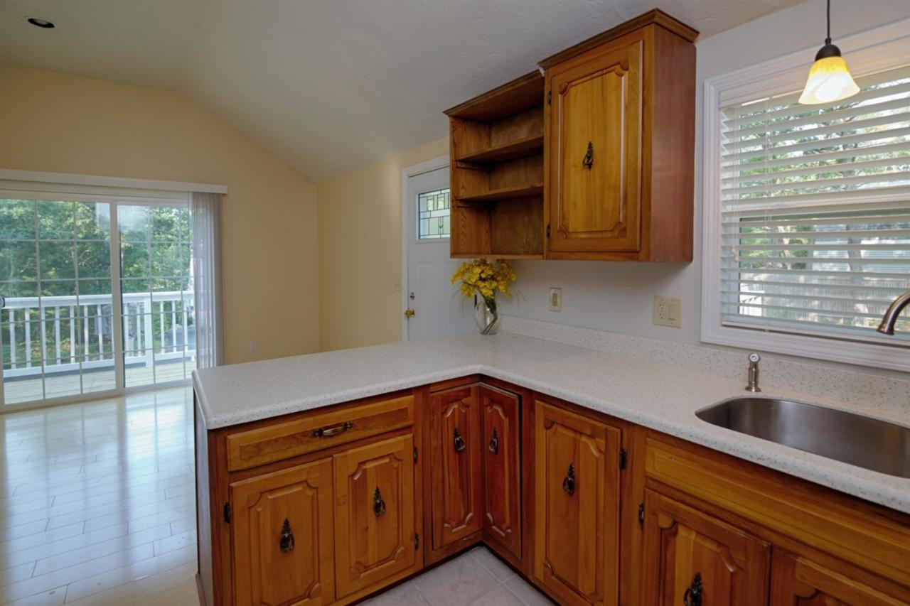 12 Santuit Pond Road Mashpee, MA 02649 - Photo 9 of 31 a kitchen with stainless steel appliances granite countertop a sink and a cabinets