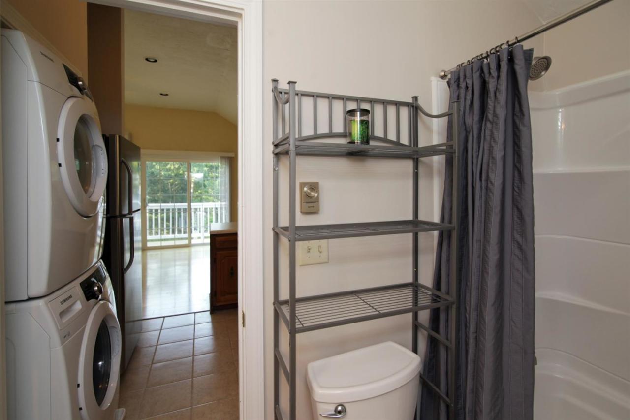 12 Santuit Pond Road Mashpee, MA 02649 - Photo 10 of 31 a bathroom with a toilet a sink and a mirror