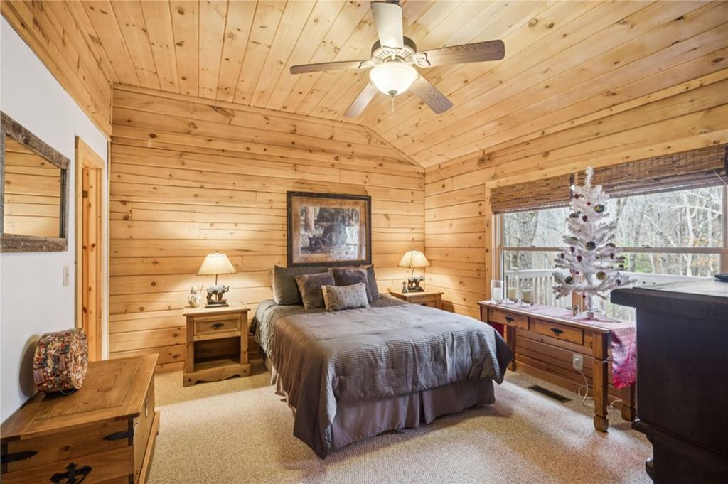 458 Tea Berry Lane Big Canoe, GA 30143 - Photo 17 of 37 a bedroom with a bed and a chandelier