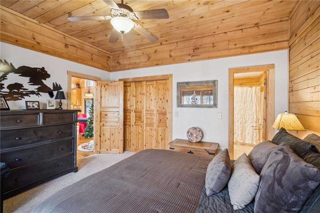 458 Tea Berry Lane Big Canoe, GA 30143 - Photo 18 of 37 a bed room with a bed and a chandelier