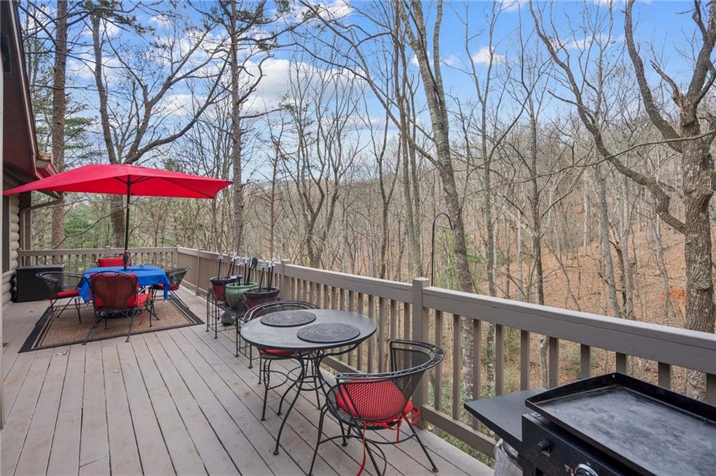 458 Tea Berry Lane Big Canoe, GA 30143 - Photo 21 of 37 a view of a balcony with chairs and wooden floor
