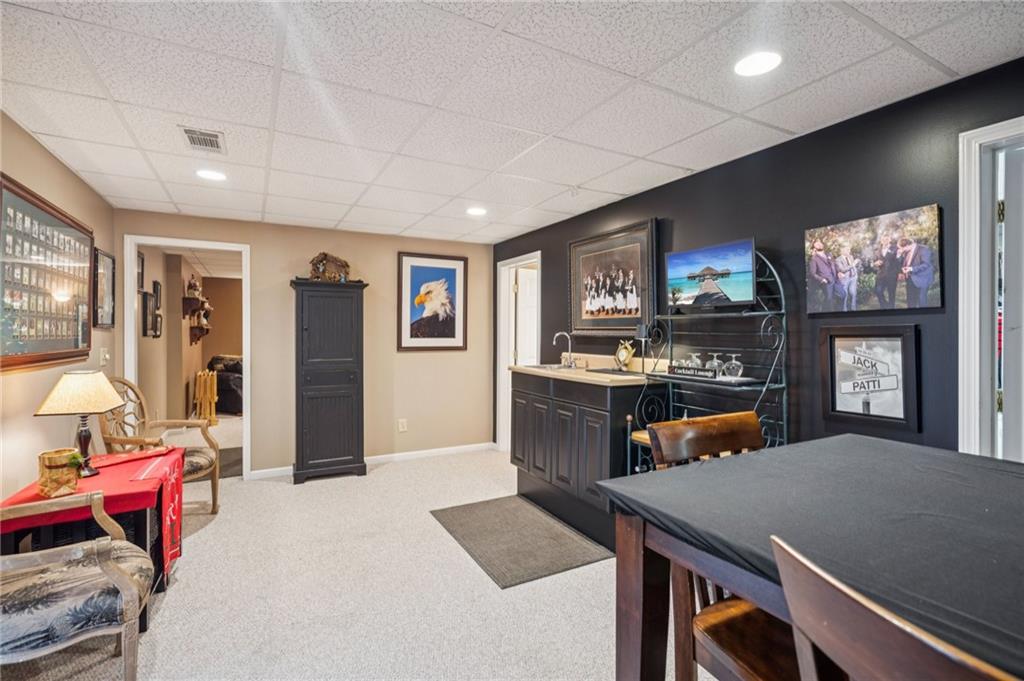 458 Tea Berry Lane Big Canoe, GA 30143 - Photo 26 of 37 a view of a dining room with furniture and a flat screen tv