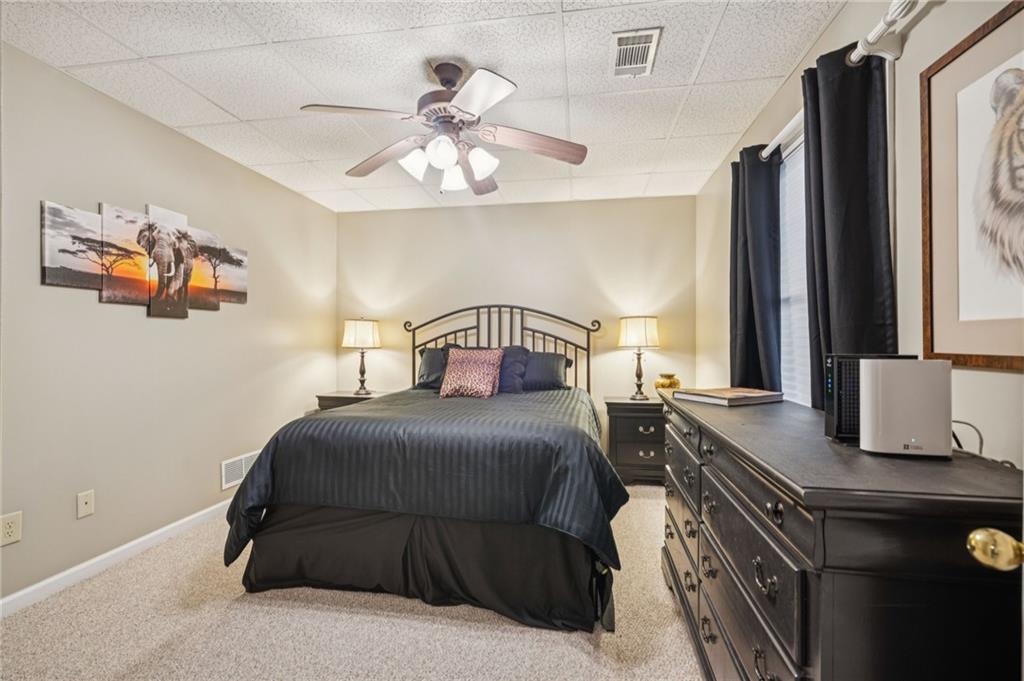 458 Tea Berry Lane Big Canoe, GA 30143 - Photo 28 of 37 a bedroom with a bed and a chandelier