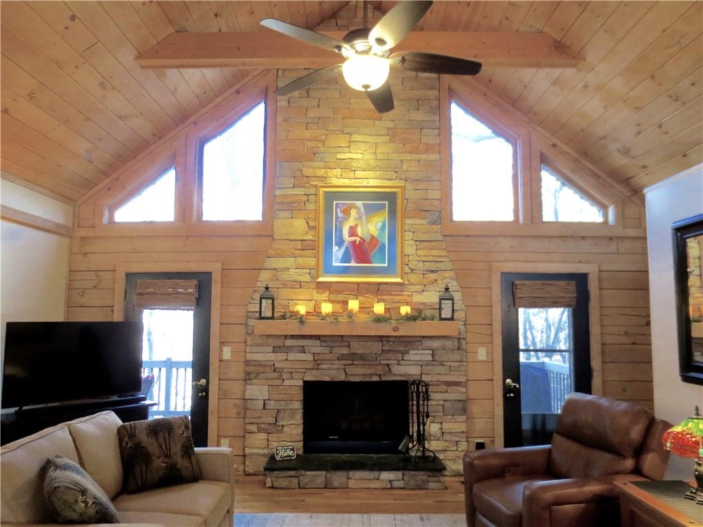 458 Tea Berry Lane Big Canoe, GA 30143 - Photo 4 of 37 a living room with furniture a fireplace and a flat screen tv