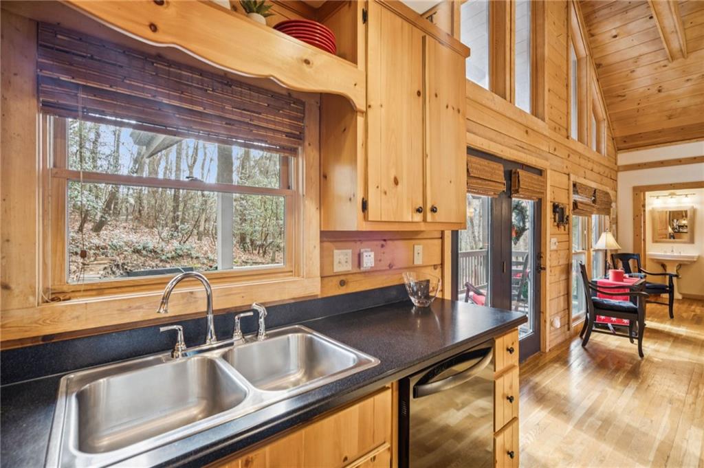 458 Tea Berry Lane Big Canoe, GA 30143 - Photo 10 of 37 a kitchen with a sink and large windows