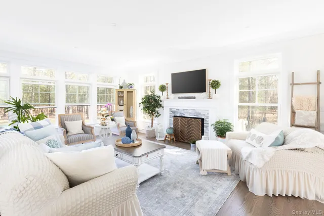 a living room with furniture a fireplace and a flat screen tv