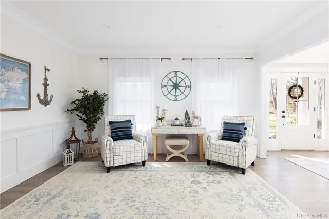 a living room with furniture and a wall painting