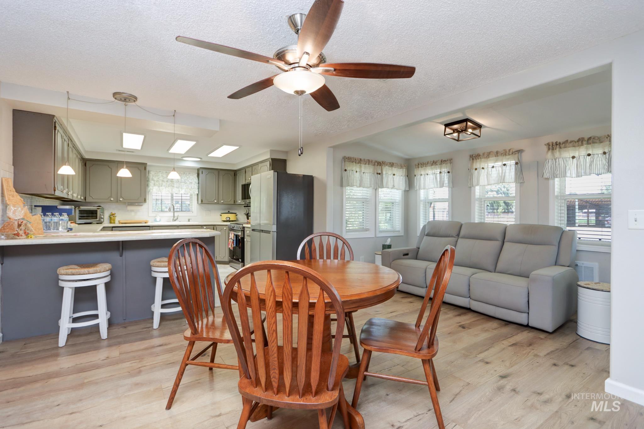 2528 Waterwheel Road Emmett, ID 83617 - Photo 27 of 50 Carpeted room featuring a ceiling fan with integrated lighting, a window with horizontal blinds, and baseboard heating