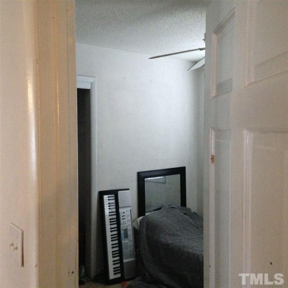 3918 Memory Lane Raleigh, NC 27604 - Photo 11 of 14 a bedroom with a bed and a mirror