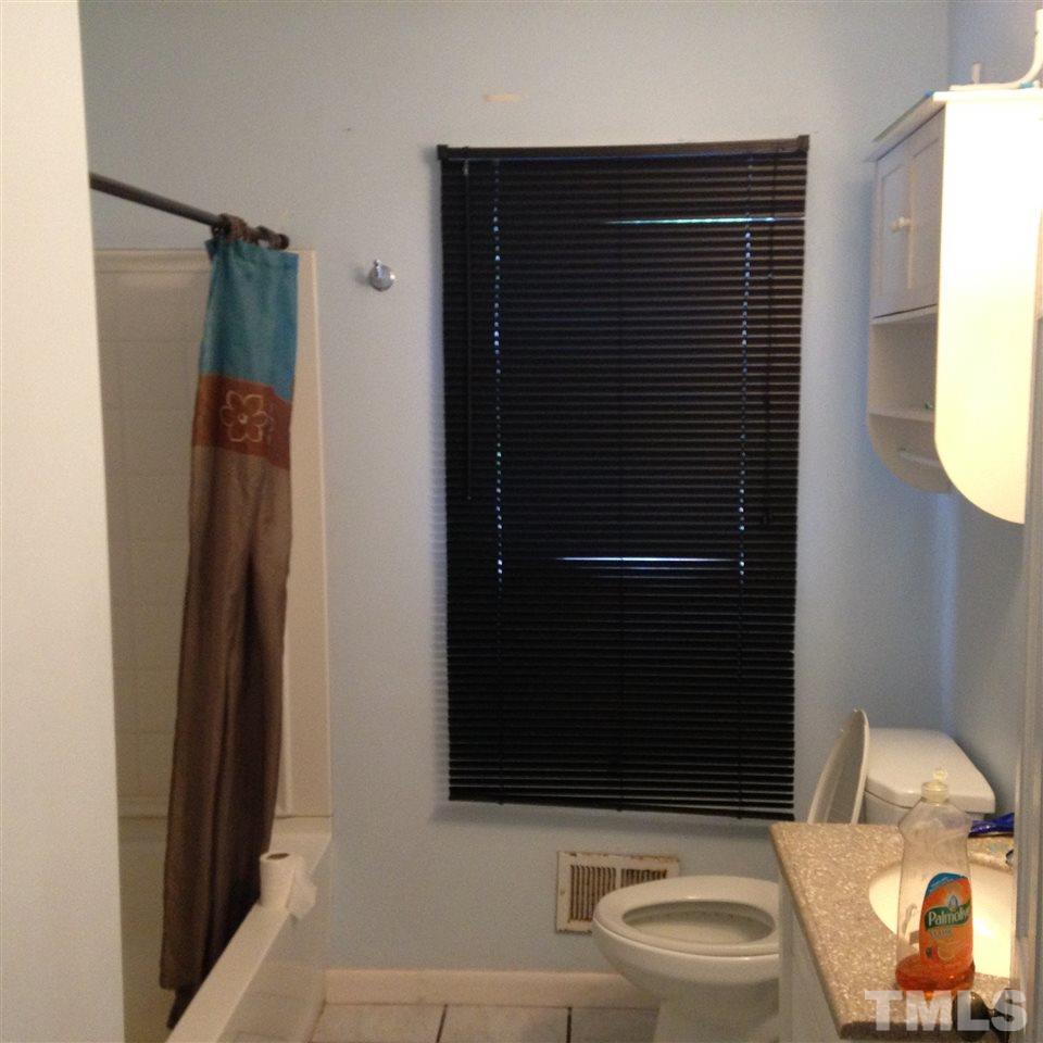 3918 Memory Lane Raleigh, NC 27604 - Photo 10 of 14 a bathroom with a shower a toilet and sink