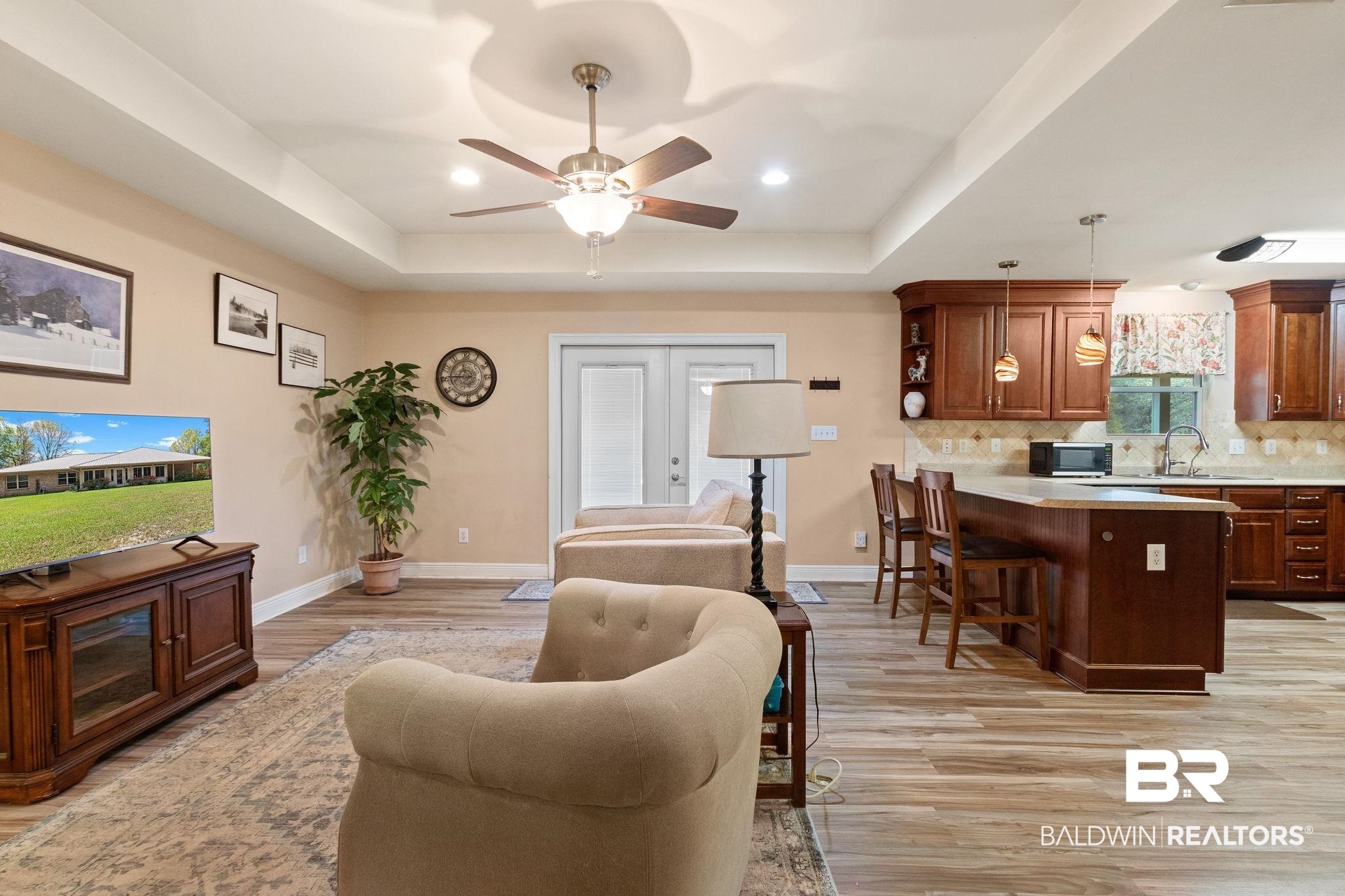 24250 Hack Road Bay Minette, AL 36507 - Photo 8 of 88 Living room featuring a ceiling fan, light wood-style flooring, a raised ceiling, recessed lighting, and french doors