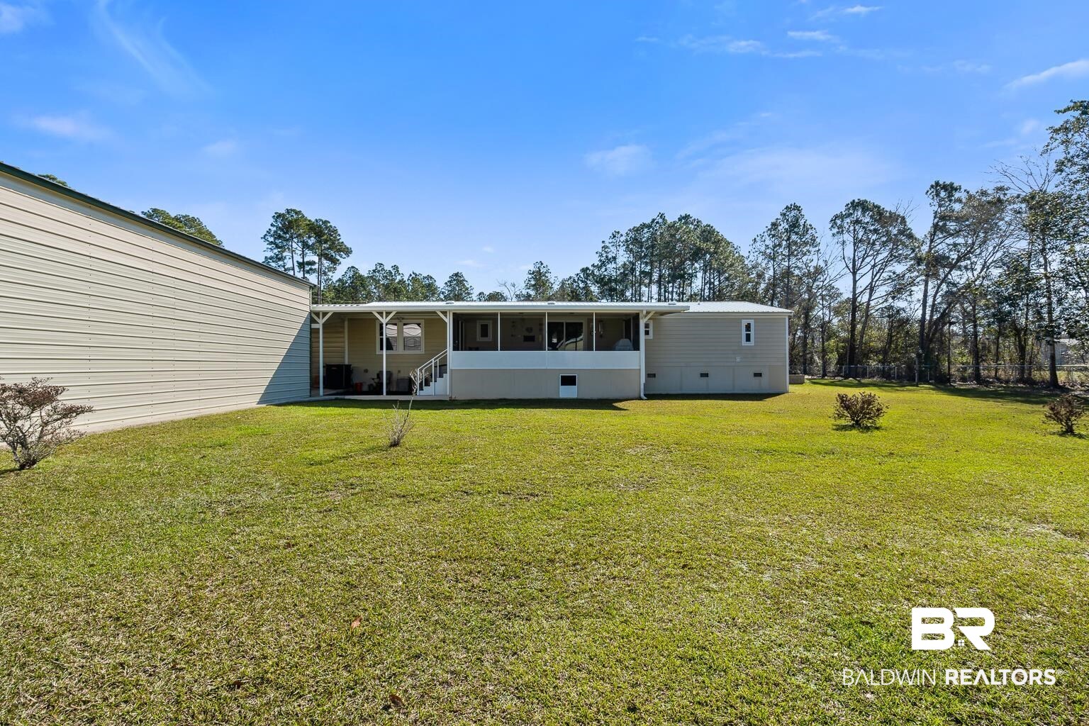 10647 Rte Road Lillian, AL 36549 - Photo 12 of 62 Back of property with a sunroom and a yard