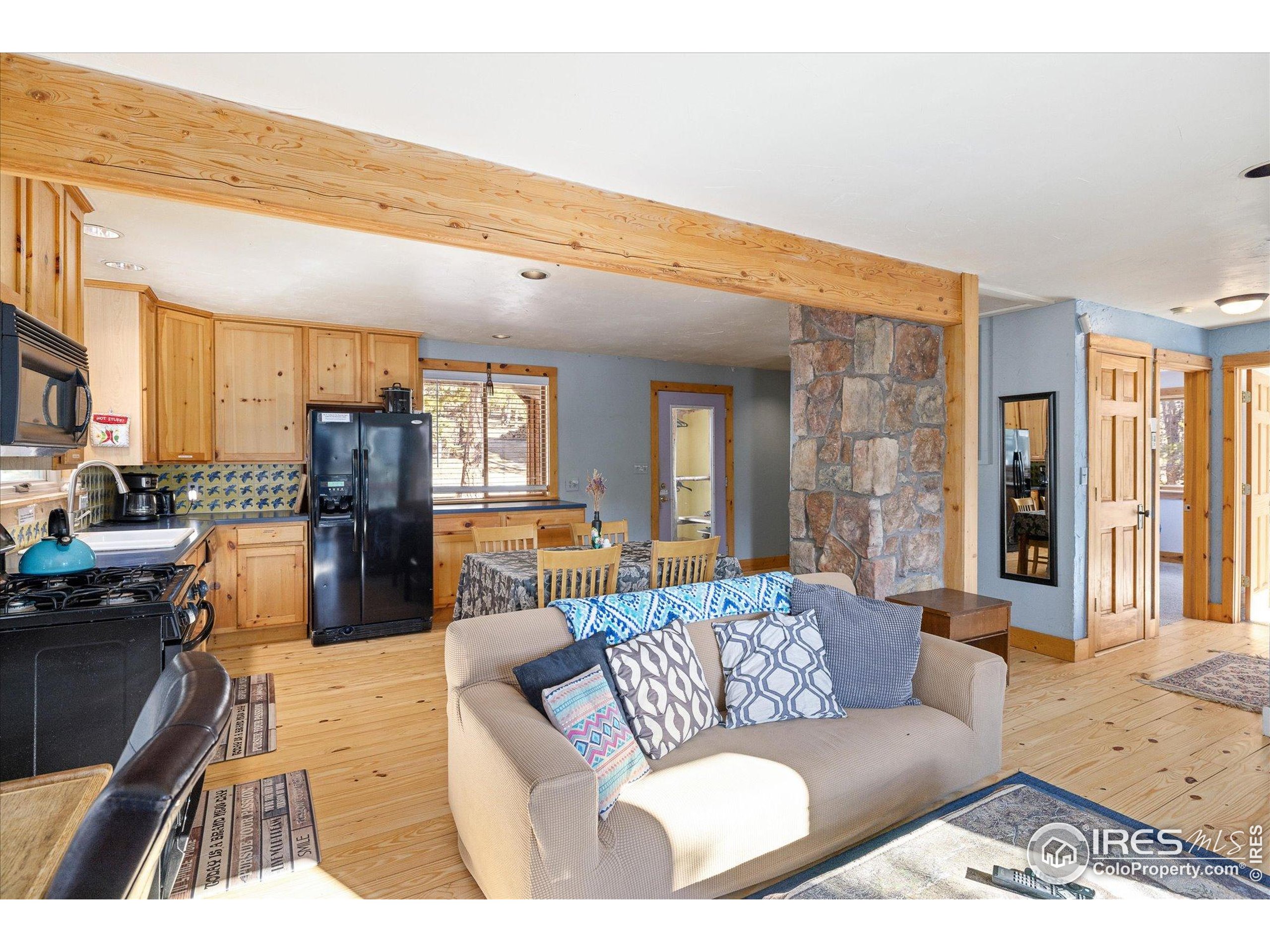 246 Rudi Lane West Golden, CO 80403 - Photo 11 of 48 a living room with furniture wooden floor and kitchen view
