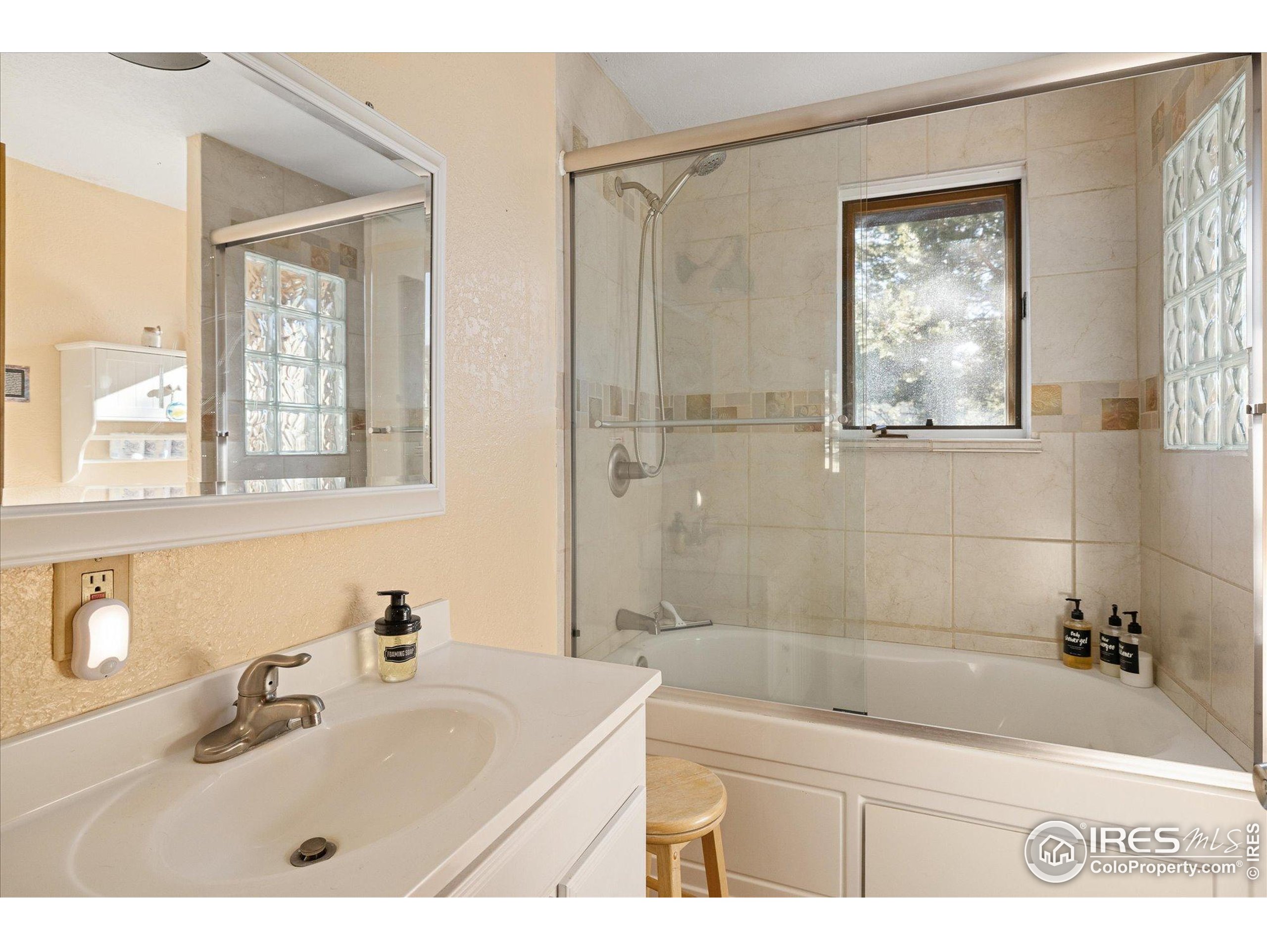246 Rudi Lane West Golden, CO 80403 - Photo 15 of 48 a bathroom with a tub a sink and mirror