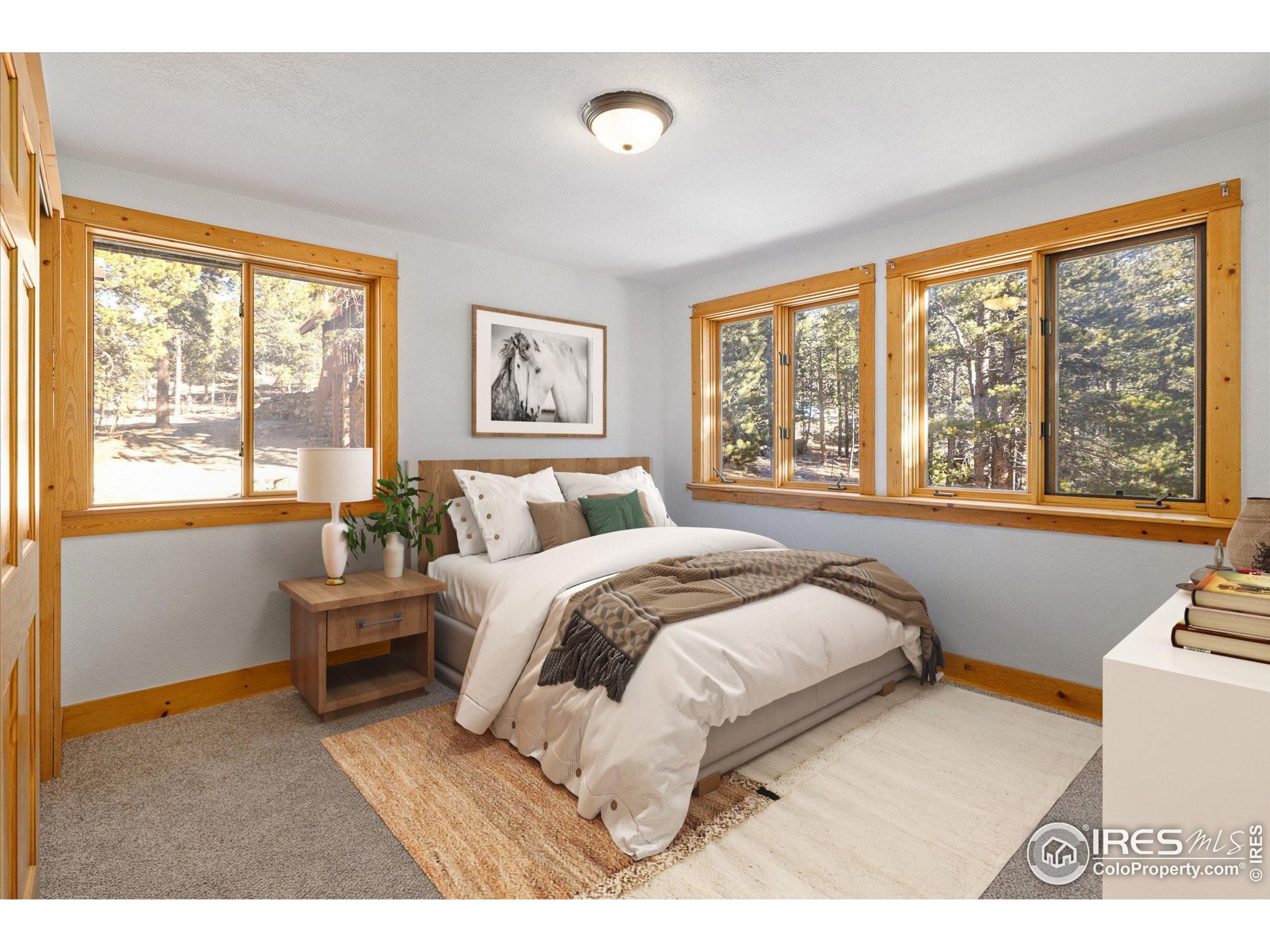 246 Rudi Lane West Golden, CO 80403 - Photo 16 of 48 a bedroom with a bed and a large window