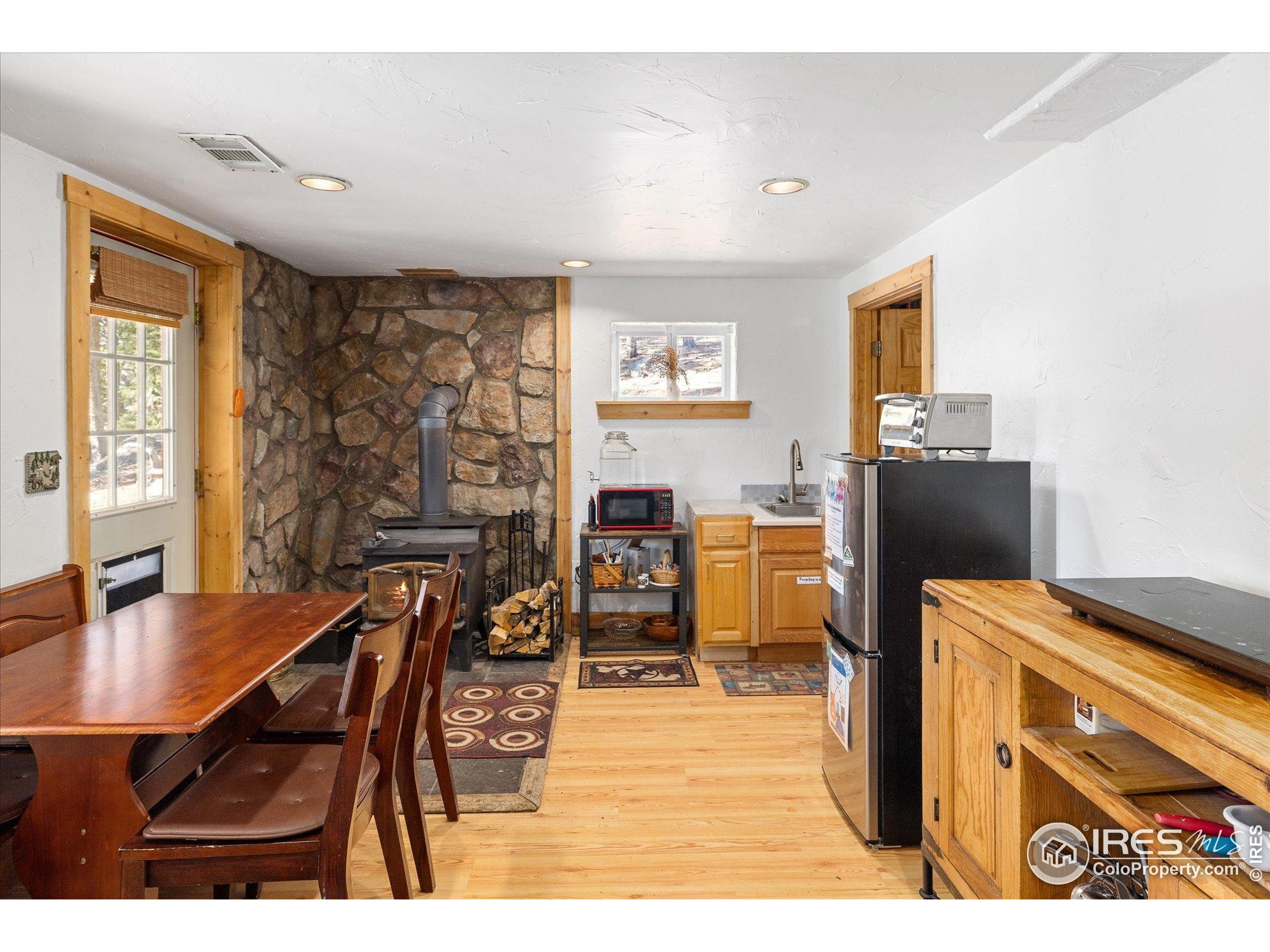 246 Rudi Lane West Golden, CO 80403 - Photo 20 of 48 a dining room with furniture and wooden floor