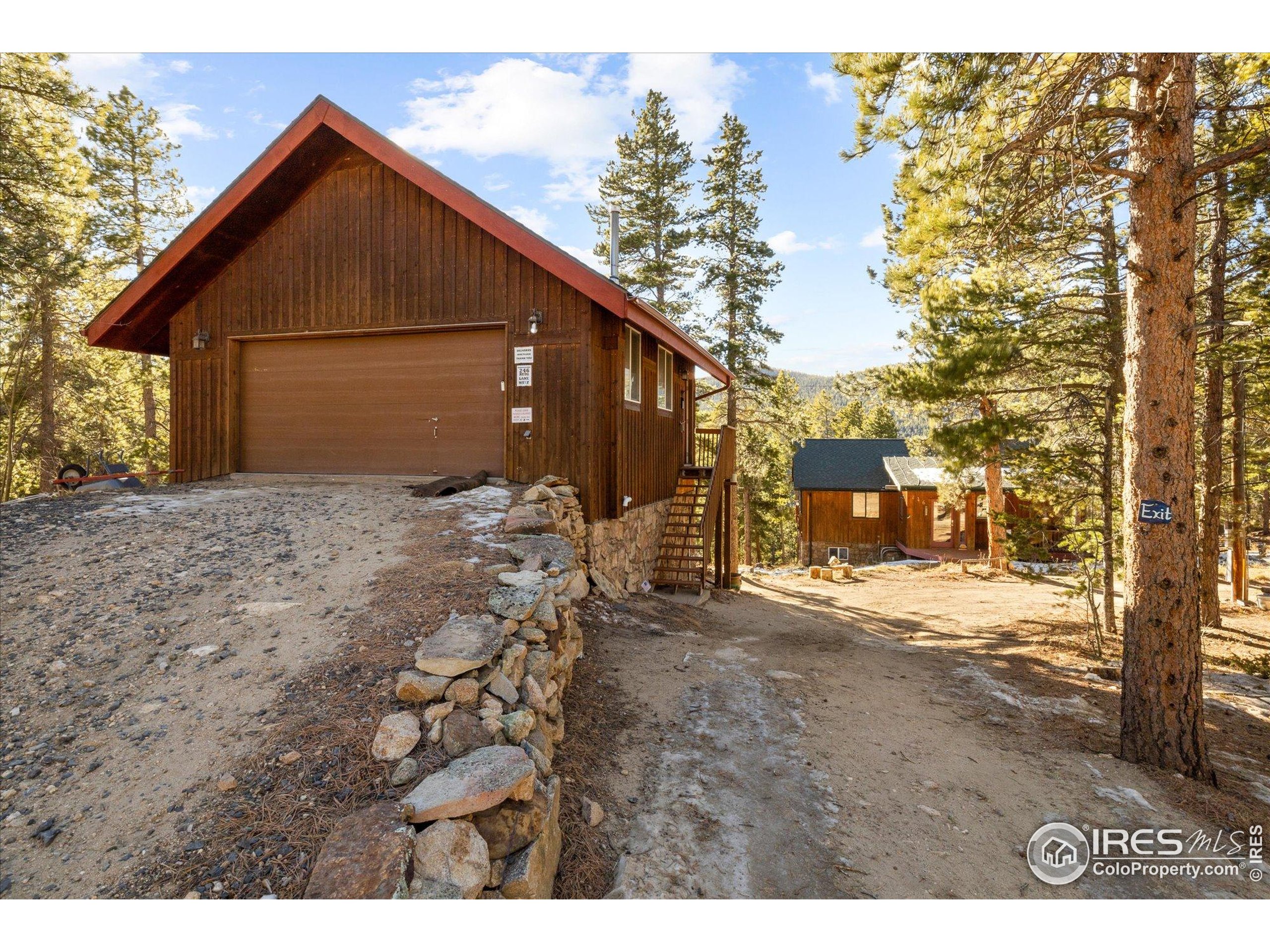 246 Rudi Lane West Golden, CO 80403 - Photo 3 of 48 a backyard of a house with large trees and wooden fence