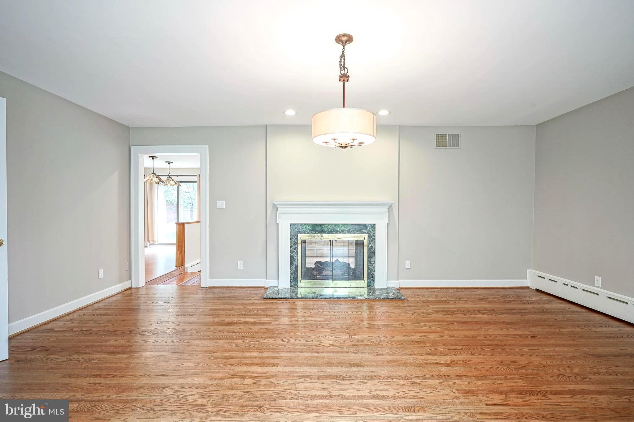 1056 Chews Landing Road Clementon, NJ 08021 - Photo 15 of 55 a view of a livingroom with wooden floor a fireplace and window
