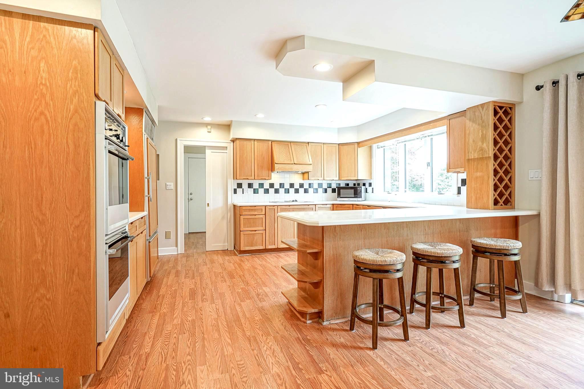 1056 Chews Landing Road Clementon, NJ 08021 - Photo 21 of 55 a kitchen with a table chairs refrigerator and window