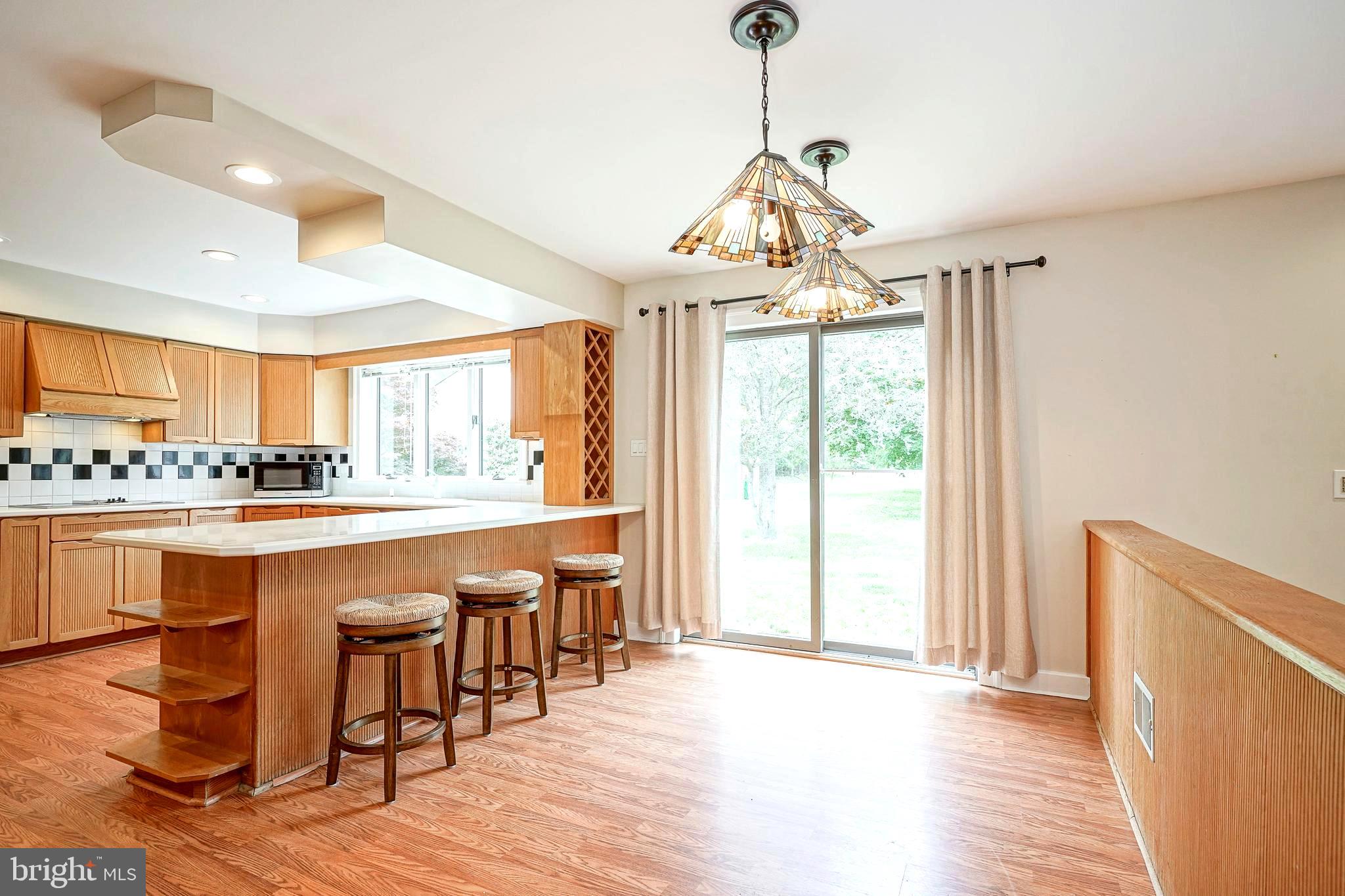 1056 Chews Landing Road Clementon, NJ 08021 - Photo 23 of 55 a open kitchen with stainless steel appliances granite countertop a stove top oven a sink dishwasher and white cabinets with wooden floor