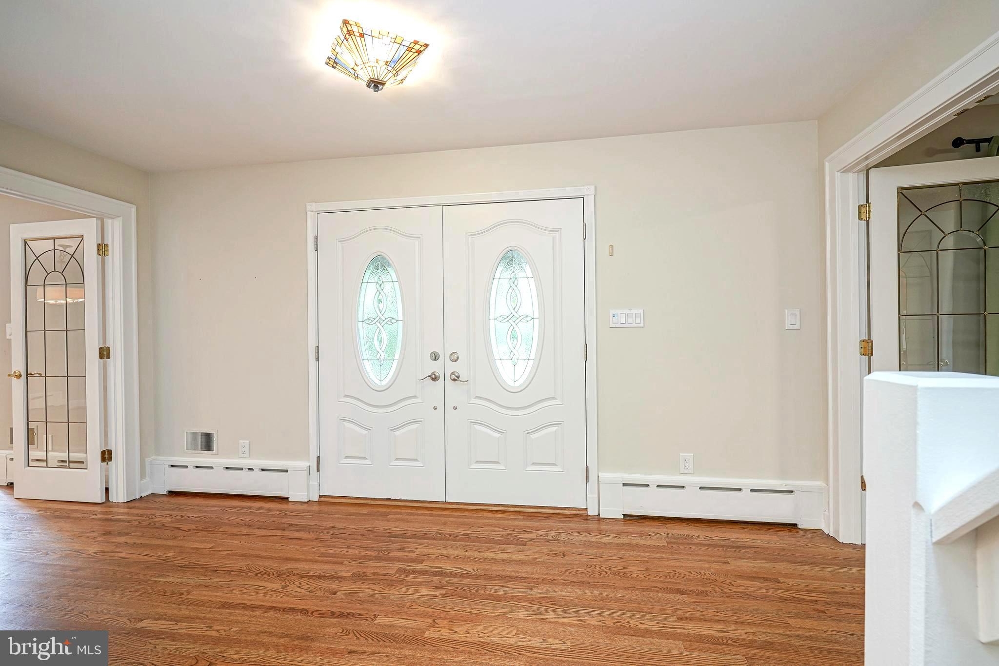 1056 Chews Landing Road Clementon, NJ 08021 - Photo 5 of 55 a view of an empty room with wooden floor and a window