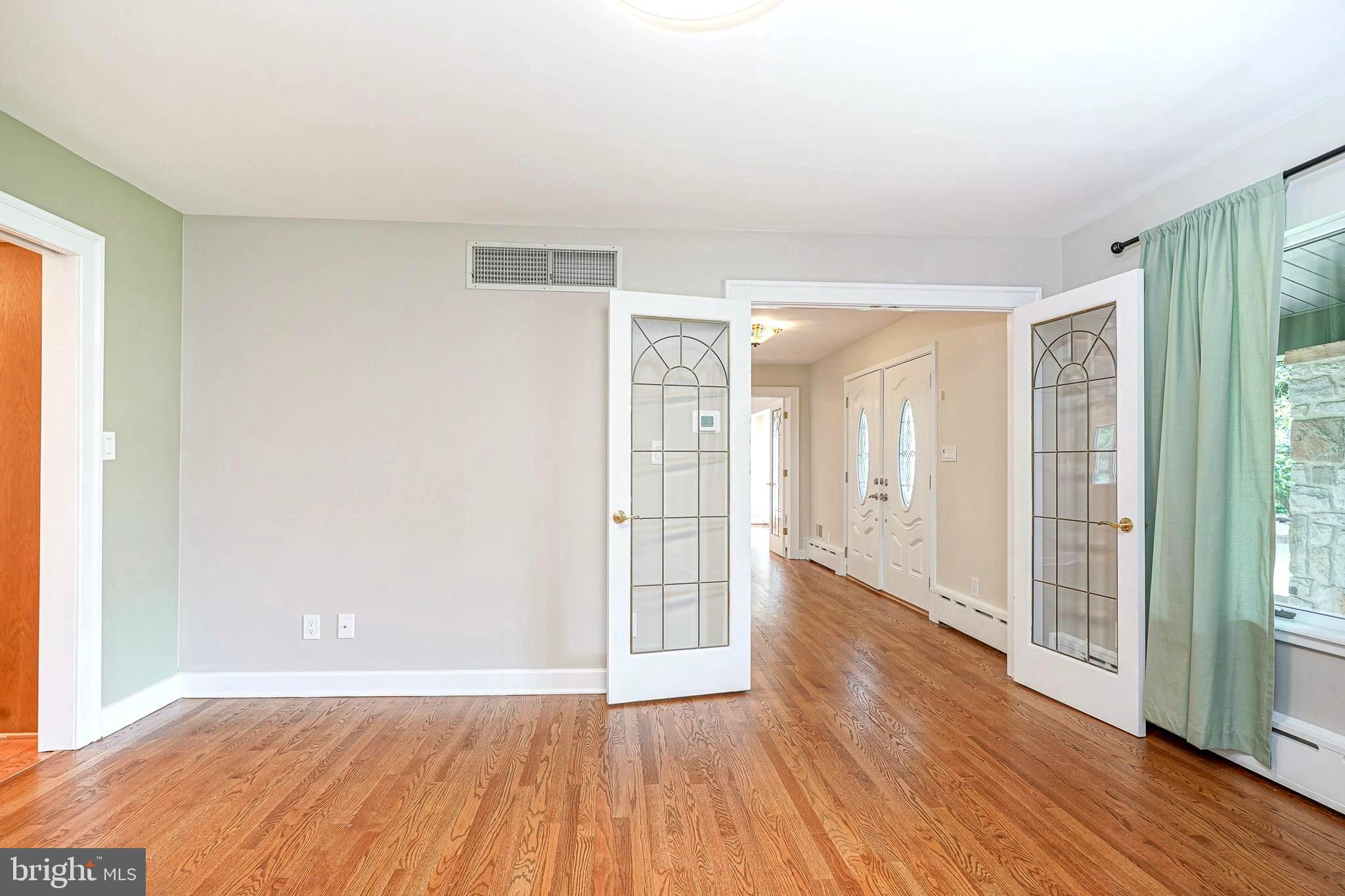 1056 Chews Landing Road Clementon, NJ 08021 - Photo 10 of 55 a view of an empty room with wooden floor and a window