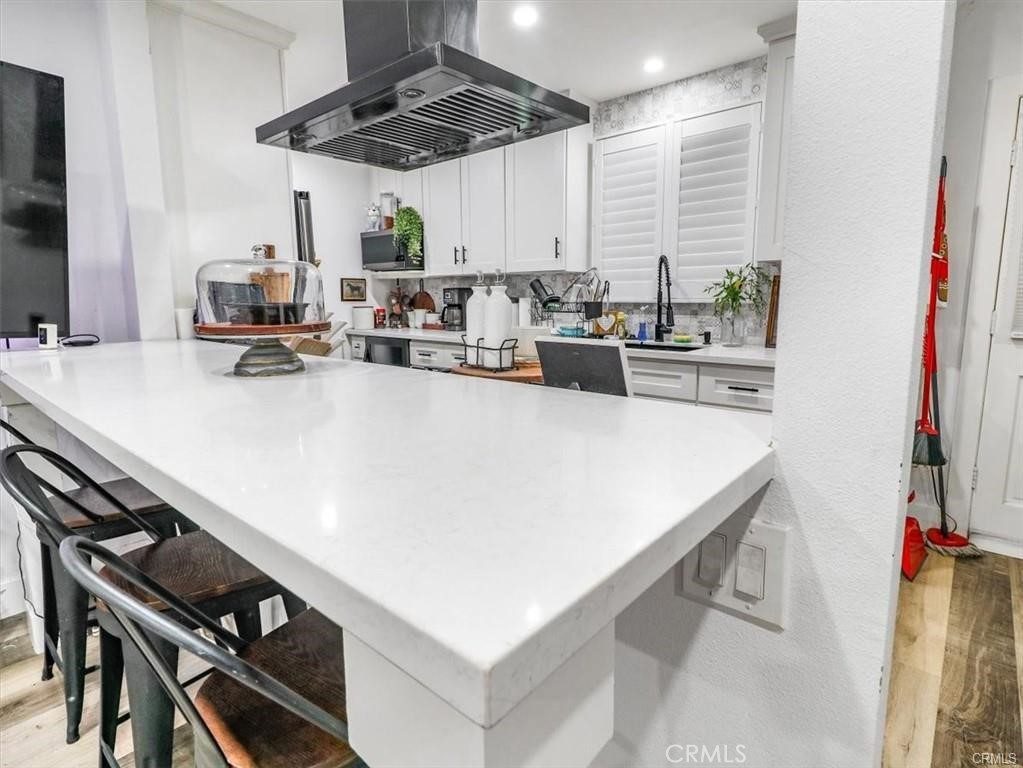 6502 Dos Rios Road Downey, CA 90240 - Photo 11 of 20 a kitchen with a sink a stove and chairs