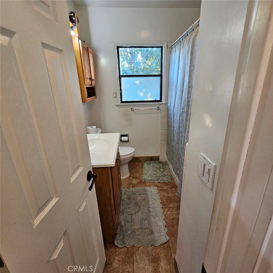 6502 Dos Rios Road Downey, CA 90240 - Photo 19 of 20 a bathroom with a sink and mirror with toilet