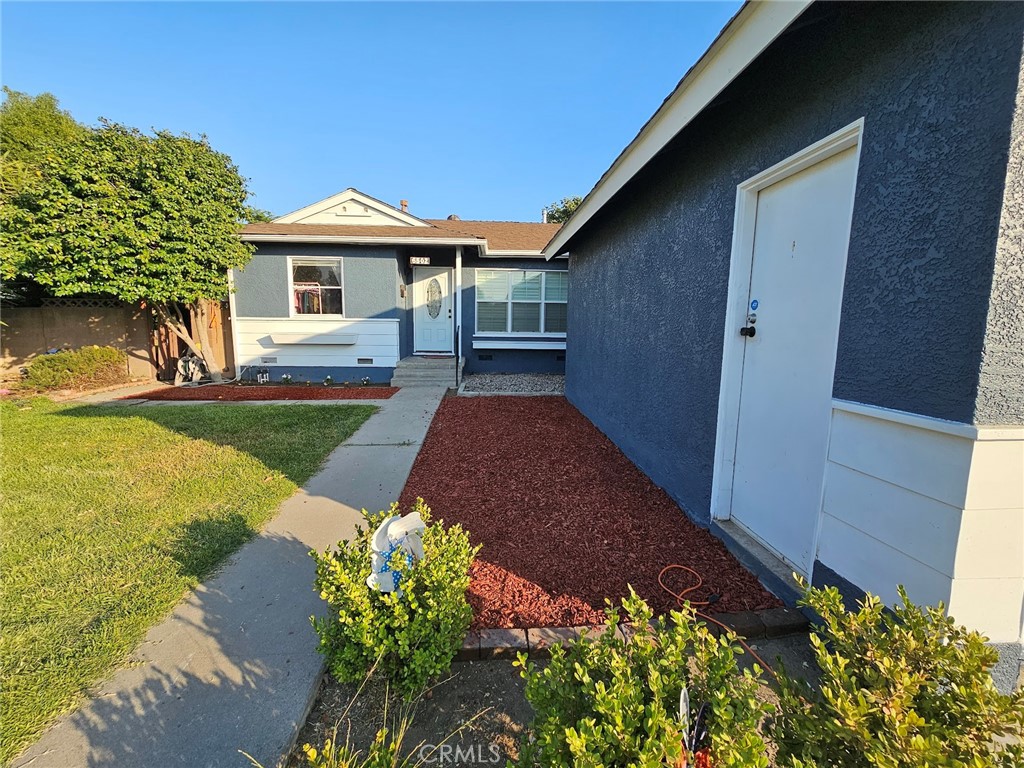 6502 Dos Rios Road Downey, CA 90240 - Photo 2 of 20 a front view of a house with a yard and garage