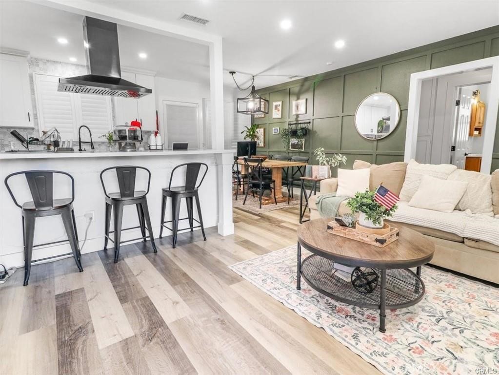 6502 Dos Rios Road Downey, CA 90240 - Photo 8 of 20 a living room with kitchen island furniture and a chandelier