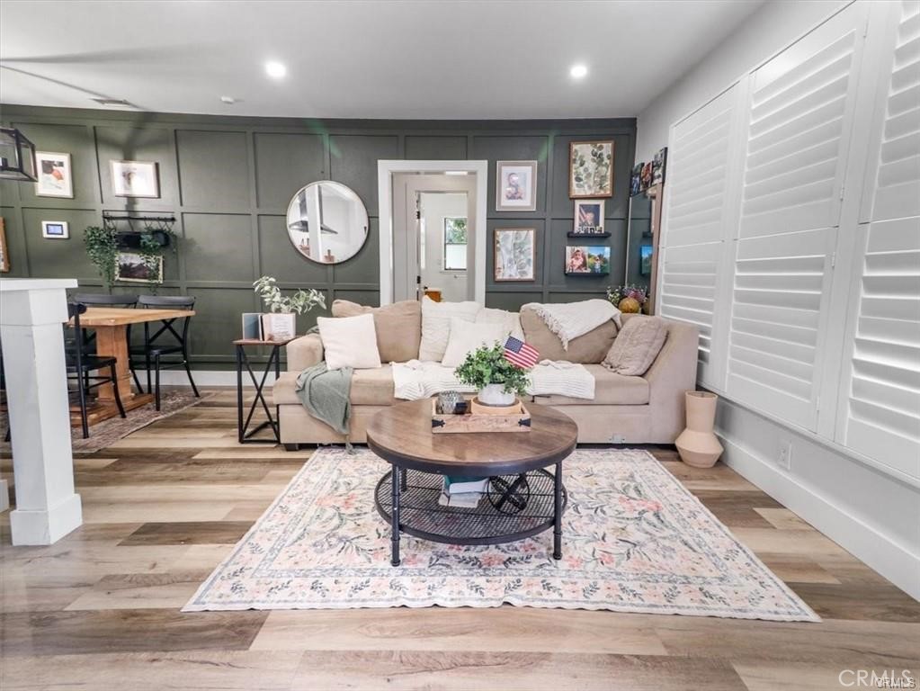 6502 Dos Rios Road Downey, CA 90240 - Photo 9 of 20 a living room with furniture a table and wooden floor