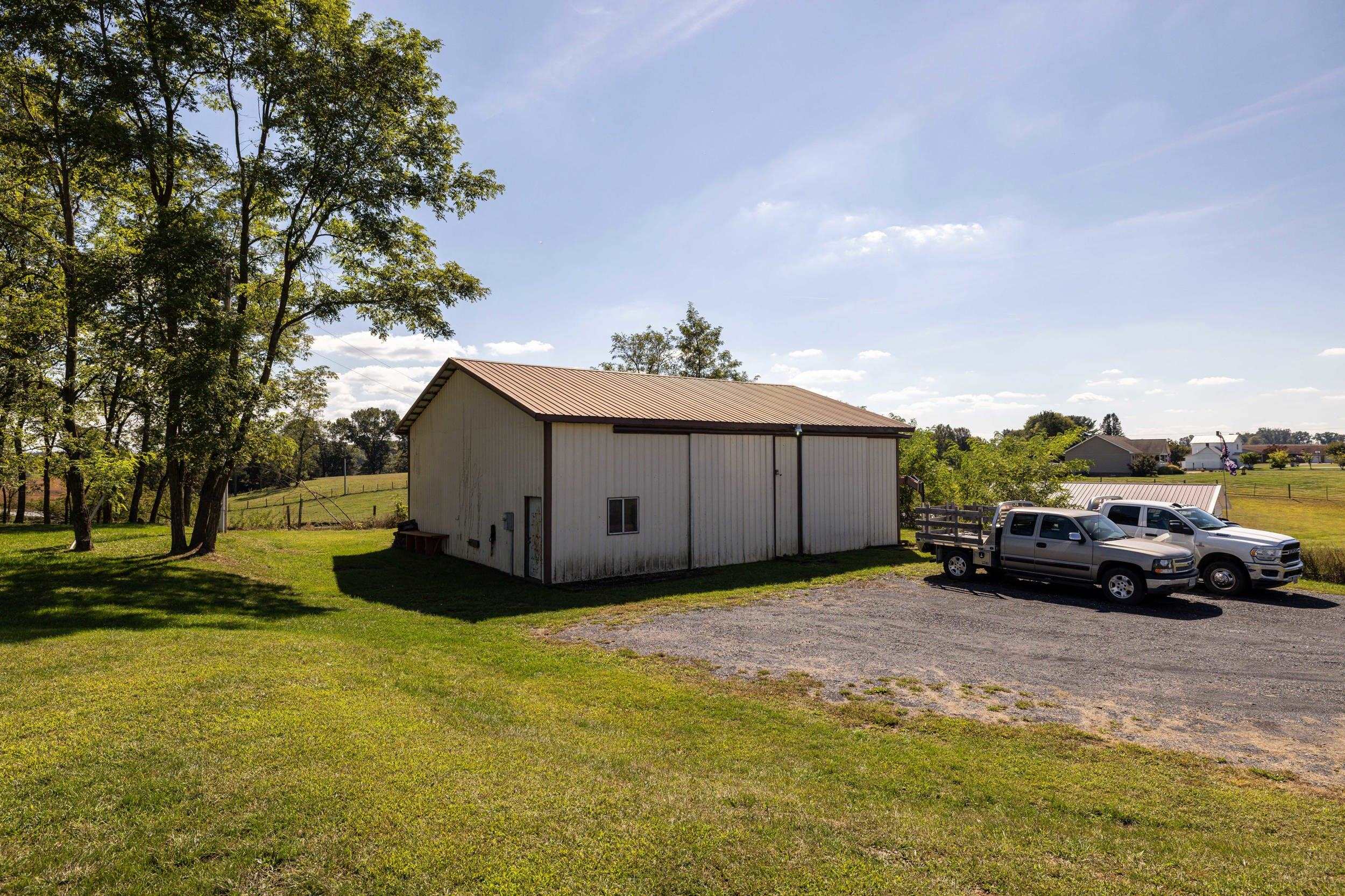 9108 Nazarene Church Road Bridgewater, VA 22812 - Photo 51 of 72 a view of a car in front of a house with a yard