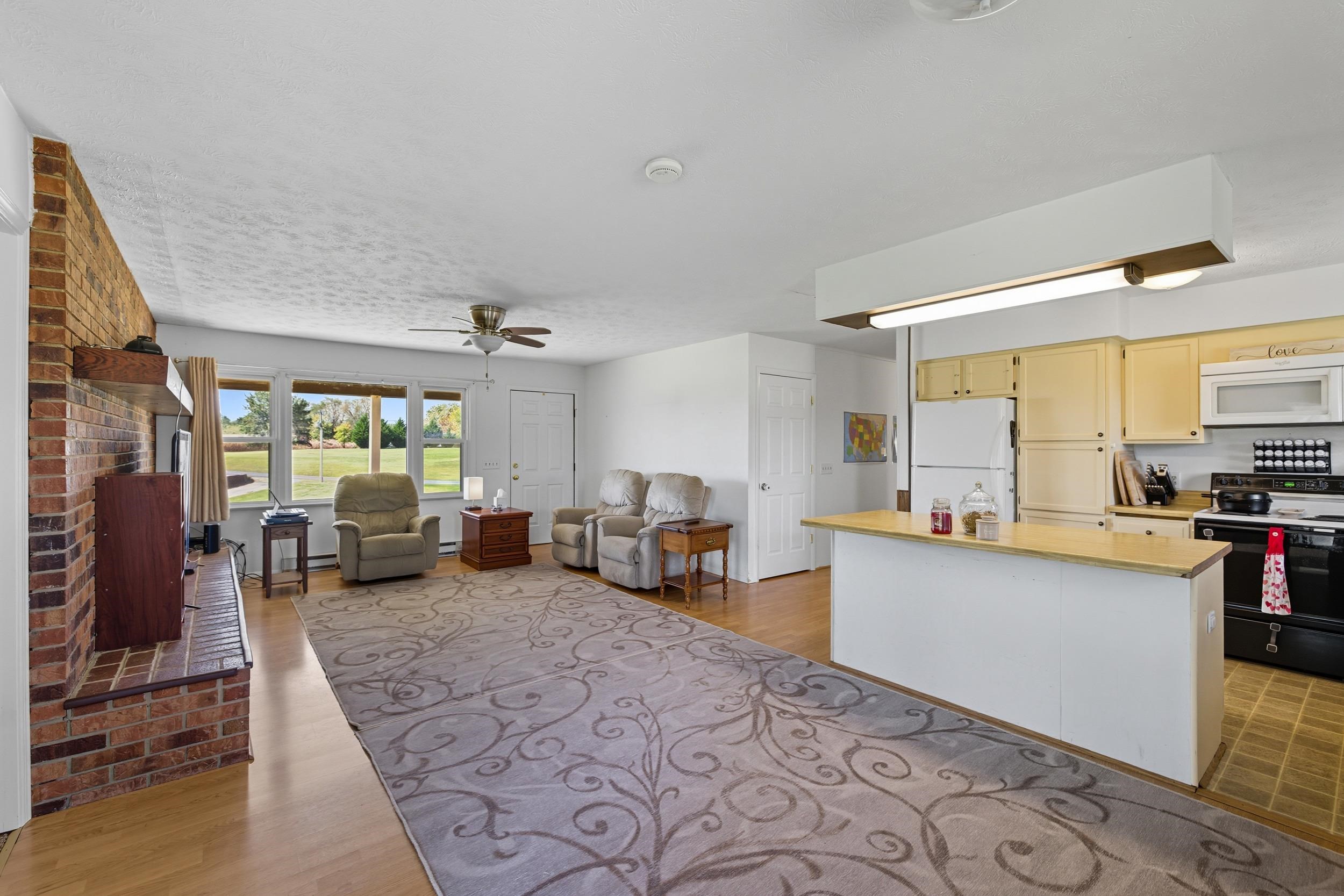 9108 Nazarene Church Road Bridgewater, VA 22812 - Photo 7 of 72 a living room with furniture large window and kitchen view