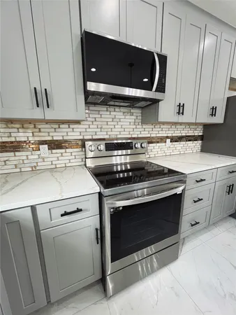 a kitchen with a stove microwave and sink