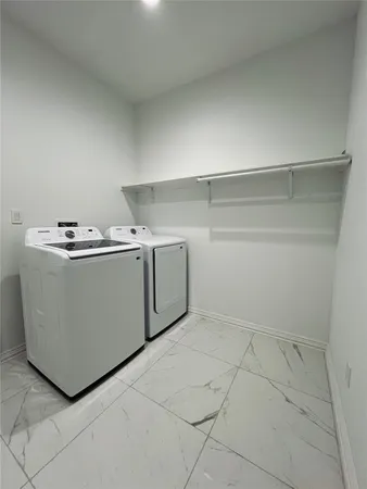 a utility room with washer and dryer
