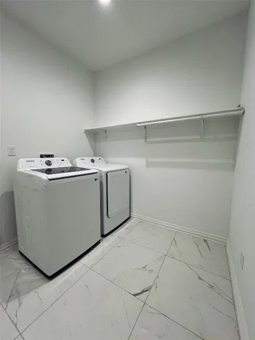a utility room with washer and dryer