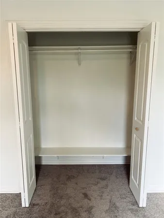 an empty room with a empty space and a ceiling fan