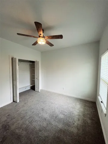 an empty room with a empty space and a ceiling fan