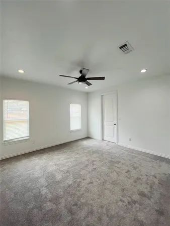 an empty room with a empty space and a ceiling fan