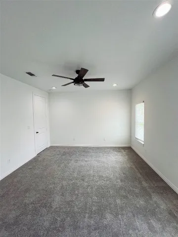 an empty room with a empty space and a ceiling fan