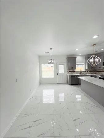a large kitchen with a stove a sink dishwasher and a refrigerator