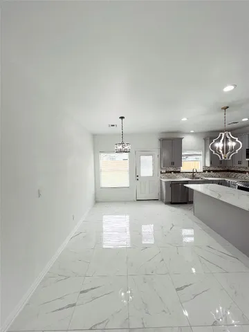 a large white kitchen with a large window