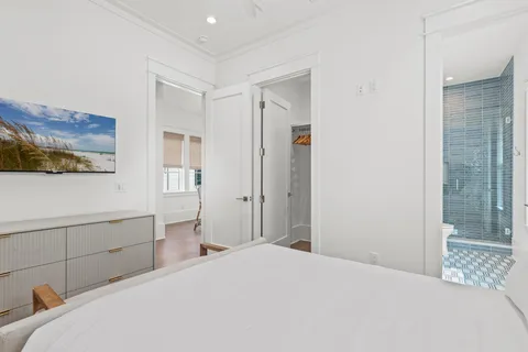 a bedroom with a bed and a view of closet