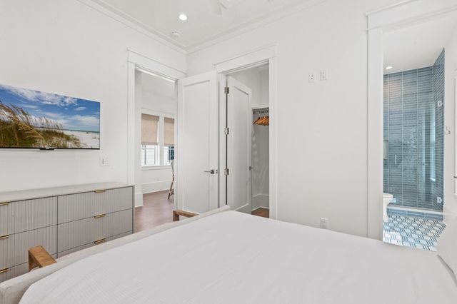 a bedroom with a bed and a view of closet