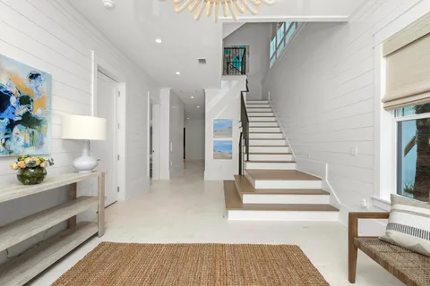 a dining room filled chandelier and wooden floor