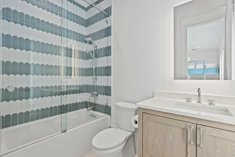 a bedroom with a bed and a night stand